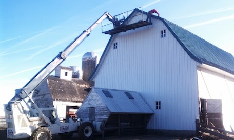 Using the highlift to work on the barn